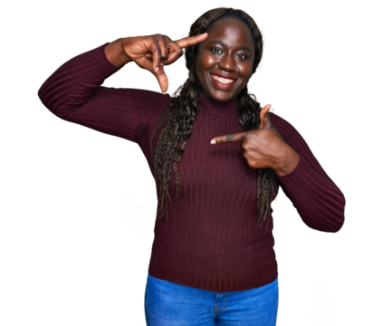 Young african woman wearing casual winter sweater smiling making frame with hands and fingers with happy face. creativity and photography concept.