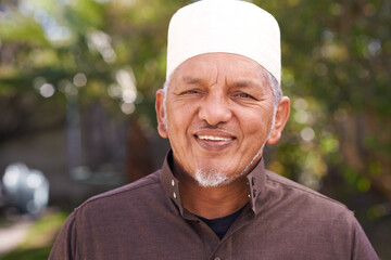 Happy, muslim and portrait of man outdoor with a smile in garden or relax on holiday in retirement. Arab, mature person and travel on vacation in summer to park or enjoy nature and trees in backyard