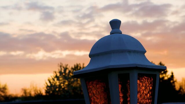 Old lantern during sunset in the background
