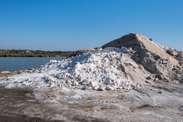 Mountains or piles of untreated salt.Salt industry. Salt flower. Industrial exploitation of salt growing in the pools of seawater between the marshes on the Atlantic coast.