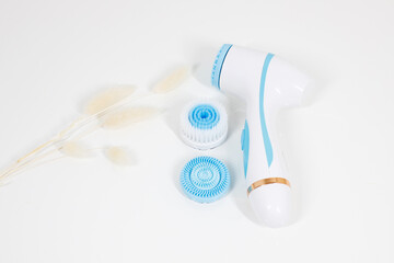 facial massager with attachments on a white background