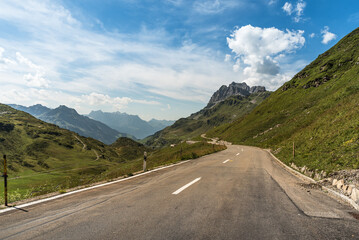 Pass road and mountain landscape at Klausen Pass, Unterschaechen, Canton of Uri, Switzerland - obrazy, fototapety, plakaty
