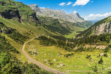 Mountain landscape and pass road at Klausen Pass, view towards Urnerboden, Spiringen, Canton of Uri, Switzerland - obrazy, fototapety, plakaty