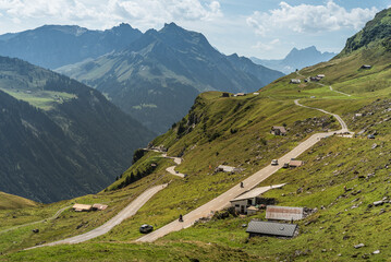 Mountain landscape with pass road and huts at Klausen Pass, Unterschaechen, Canton of Uri,...