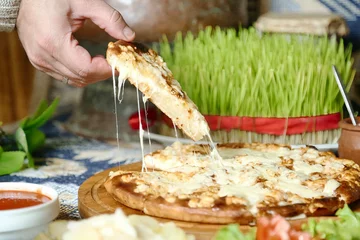 Foto op Plexiglas Person Enjoying a Slice of Pizza at a Pizza Parlor © uhdenis