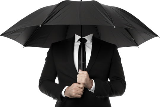 A businessman in a suit holds a black umbrella for protection from the rain