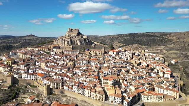 Aerial view of medieval and historic city, Morella. Ancient walled city located on a hill-top in the province of Castell&oacute;n, Valencian Community, Spain. Drone going backward. Famous travel destination.
