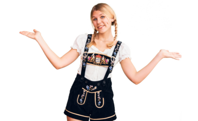 Young beautiful blonde woman wearing oktoberfest dress smiling showing both hands open palms, presenting and advertising comparison and balance