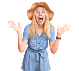 Young beautiful blonde woman wearing summer hat and dress celebrating crazy and amazed for success with arms raised and open eyes screaming excited. winner concept