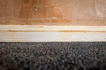 sanded wooden skirting board closeup during home renovation
