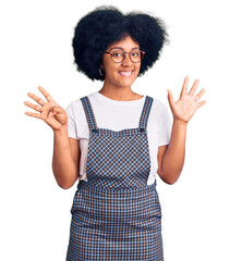 Young african american girl wearing casual clothes showing and pointing up with fingers number nine while smiling confident and happy.