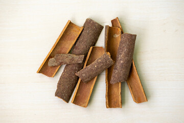 Cinnamon sticks on a wooden background. Its scientific name is Cinnamomum verum and also known as darchini, daruchini, dalchini, cinnamon quills, cassia bark, or cinnamon twig.