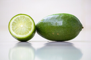Fresh sliced lemon and whole lemon isolated on a white background. In the Bengali language, it is called Lebu. 