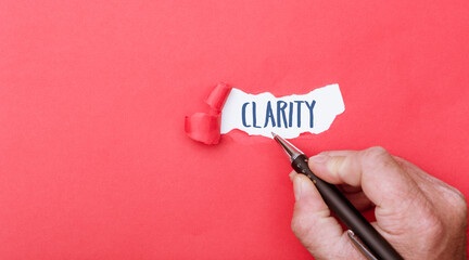 Clarity, word written on ripped paper background