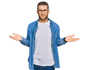 Young caucasian man wearing casual clothes clueless and confused with open arms, no idea concept.