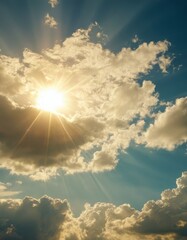 The radiant sun beams through expansive cumulus clouds, creating a breathtaking sunburst effect that illuminates the vast blue sky