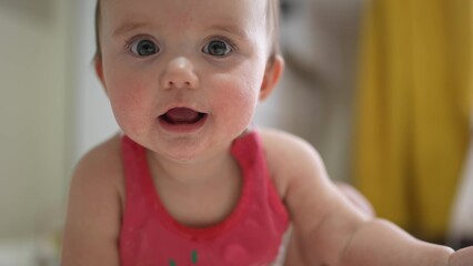 Portrait of a smiling baby holding their beloved toy in their hands. Portrait baby holding their toy, captured in close-up indoors. Indoor close-up portrait of an adorable baby playing with toy fun - 767820668