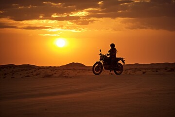 Obraz na płótnie Canvas motorcycles are silhouetted against a sunset in a vast, tranquil desert,