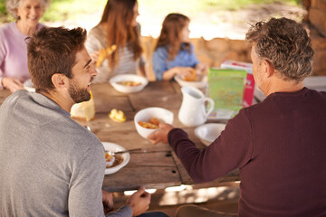 Outdoor, women and men with family for picnic in nature of backyard of house, smile and joy. Group...