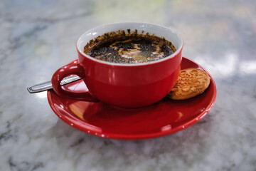 Hot black Java coffee on red ceramic cup