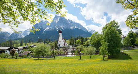 pictorial spring landscape Obergrainau, with view to Wetterstein alps and rural church