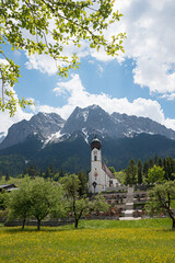 idyllic spring landscape with church and graveyard, Grainau upper bavaria