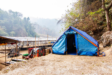 5th March, 2024, Jayanti river, Buxe tiger reserve, Alipur Duar, West Bengal, India: A devotee staying at temporary tented camp near Mahakaal cave at Buxa Jayanti on the ocation od Maha Shiv Ratri.