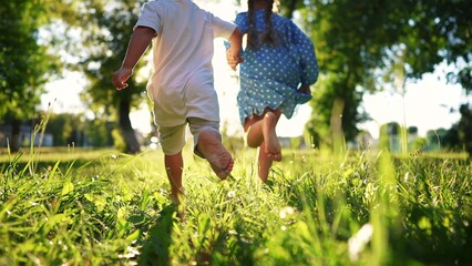 children in the park. bare feet close up a children running. happy family kid dream concept....