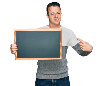 Handsome young man holding blackboard smiling happy pointing with hand and finger