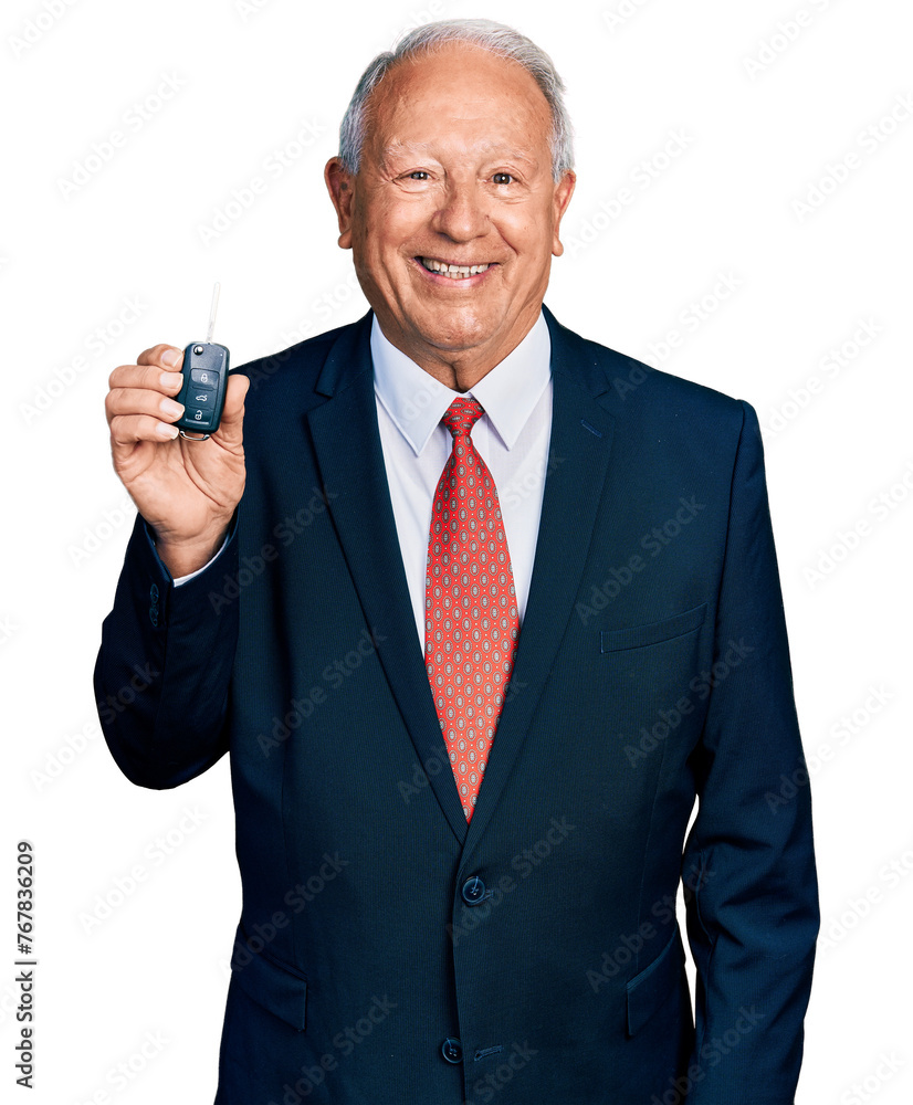 Sticker Senior business man with grey hair holding key of new car looking positive and happy standing and smiling with a confident smile showing teeth