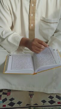 Asian moslem praying in mosque. islamic religion. During Ramadan he often prays in the mosque, worships, reads the Koran, makes dhikr, and prays to Allah.