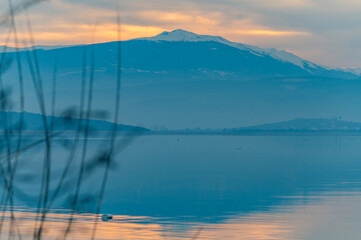 Balıkesir Lake Manyas at sunset boats reflection vegetation cloudy sky