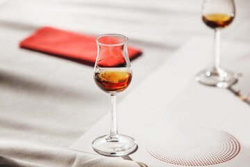 Whisky Tulip Glass on Sunlit Table, Close-up