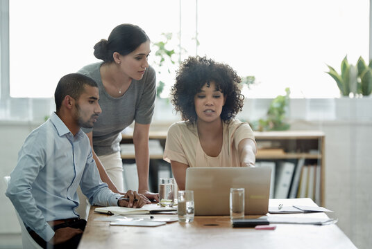 Business people, meeting and colleagues with laptop for planning, collaboration and discussion in office. Teamwork, professional and diverse employees by technology for brainstorm, research or idea