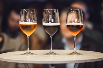 Three Different Sort of Beer in Glasses - Lager, Unfiltered and Stout on table, Close-up