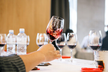 Sommelier Swirling Glass with Red Wine, Close-up