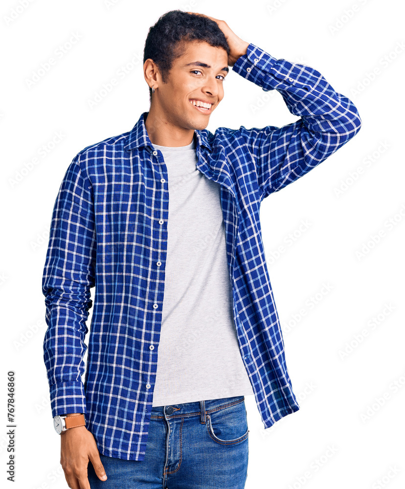 Wall mural Young african amercian man wearing casual clothes smiling confident touching hair with hand up gesture, posing attractive and fashionable