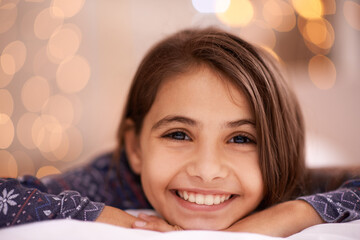 Kids, portrait and happy girl relax in a house for vacation, resting or break with light and bokeh...