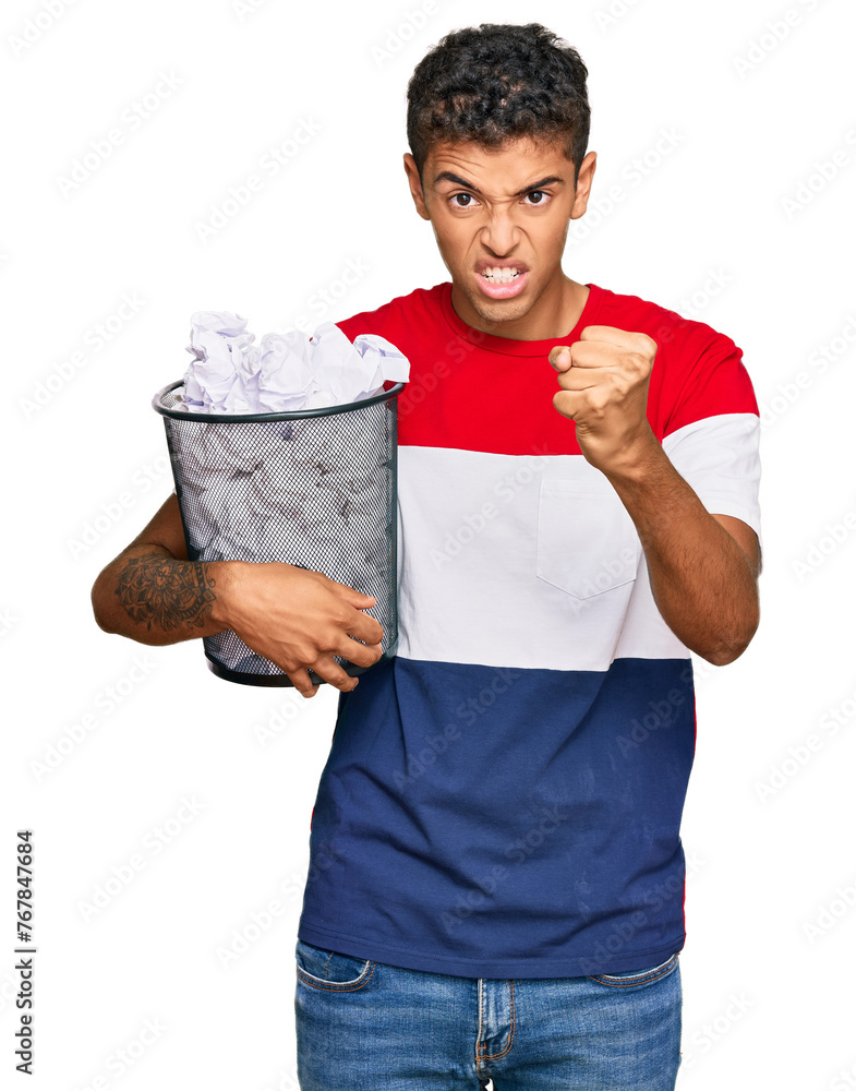 Poster Young handsome african american man holding paper bin full of crumpled papers annoyed and frustrated shouting with anger, yelling crazy with anger and hand raised