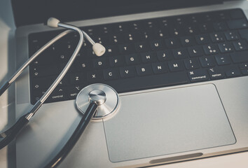 Stethoscope on laptop keyboard. Health care, remote medical examination. Healthcare business concept