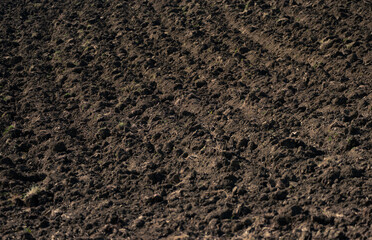 Closeup of a plowed field ready for planting. Cultivations on the hills. Bio agriculture concept.