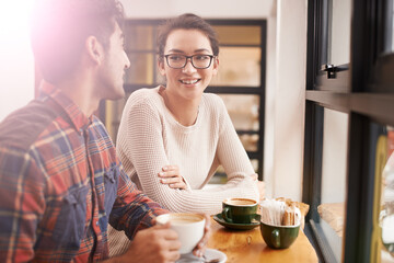 Happy people, friends and relax with coffee at cafe for chatting, talking or social bonding. Young man and woman with smile for conversation, beverage or morning drink at indoor restaurant together