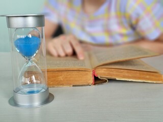 Little girl studying at home on time management concept