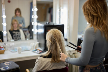 Hair straightening in back stage dressing room
