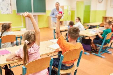 Students raising hand during QNA in class