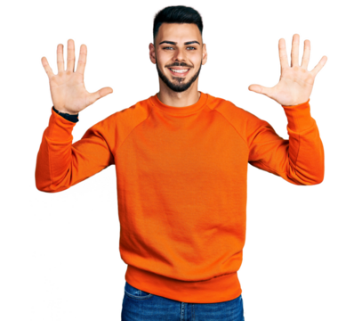 Young hispanic man with beard wearing casual orange sweater showing and pointing up with fingers number ten while smiling confident and happy.
