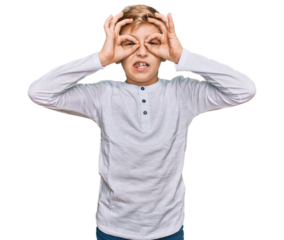 Little caucasian boy kid wearing casual clothes doing ok gesture like binoculars sticking tongue out, eyes looking through fingers. crazy expression.