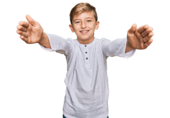 Little caucasian boy kid wearing casual clothes looking at the camera smiling with open arms for hug. cheerful expression embracing happiness.