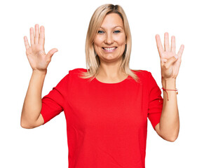 Middle age caucasian woman wearing casual clothes showing and pointing up with fingers number nine...