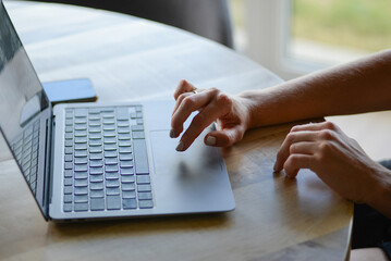 hands of business person working on laptop
